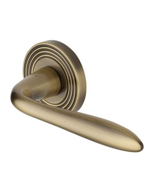 Heritage Brass Door Handle Lever Latch on Round Rose Sutton Reeded Design Antique Brass finishUK Registered Design Number 6204750