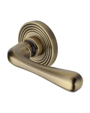 Heritage Brass Door Handle Lever Latch on Round Rose Charlbury Reeded Design Antique Brass finishUK Registered Design Number 6226298